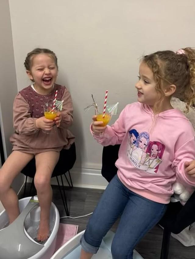 Girls enjoying mocktails with their feet in foot spa basins